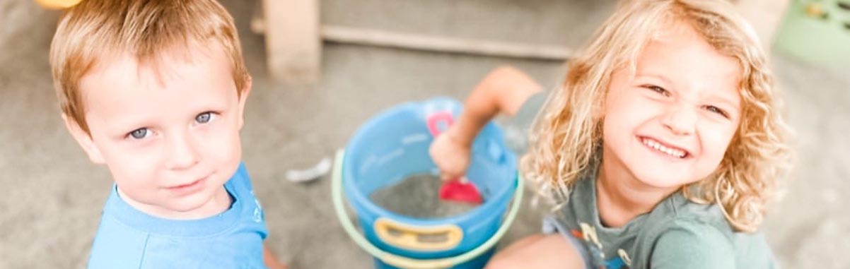 kids playing in sand staring at camera Kids Playing In Sand Staring At Camera